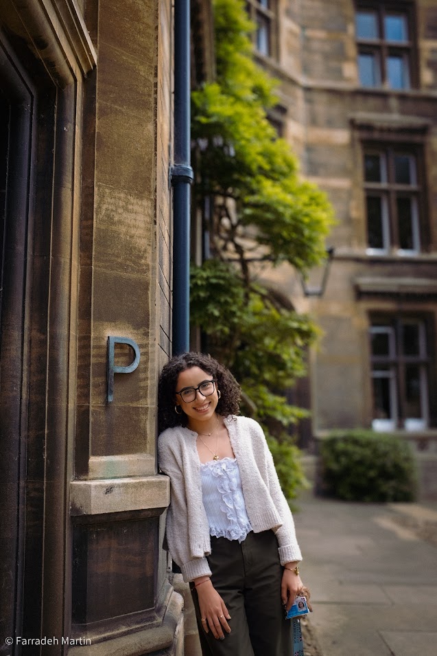 Landscape photo of Paulina Pimentel-Mora leaning against the wall of a university building