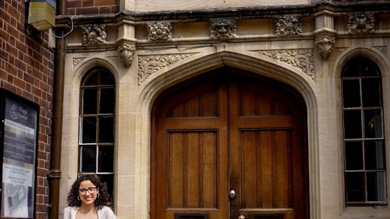 Portrait photo of Paulina Pimentel-Mora standing outside the HPS department building