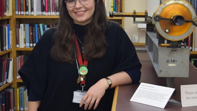 Liz White standing in the Whipple Library