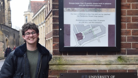 Keir Hess standing outside the entrance to the department