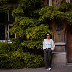 Landscape photo of Paulina Pimentel-Mora standing in front of an arch doorway. 